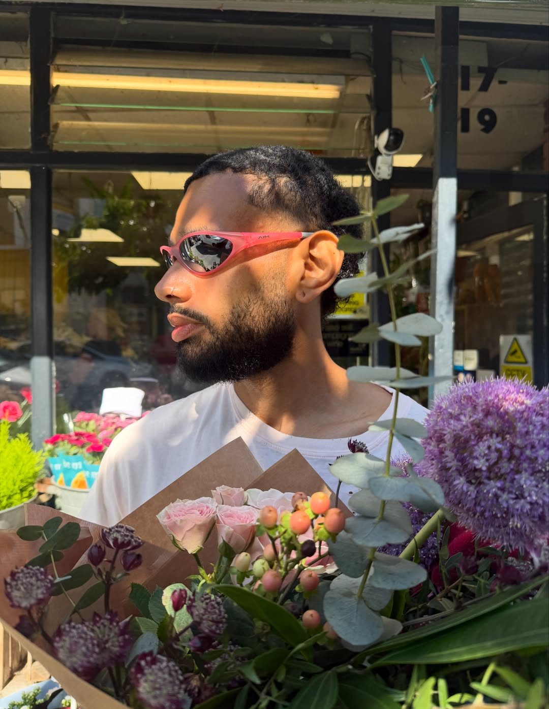 A customer wearing AIM Sunnies - Rose