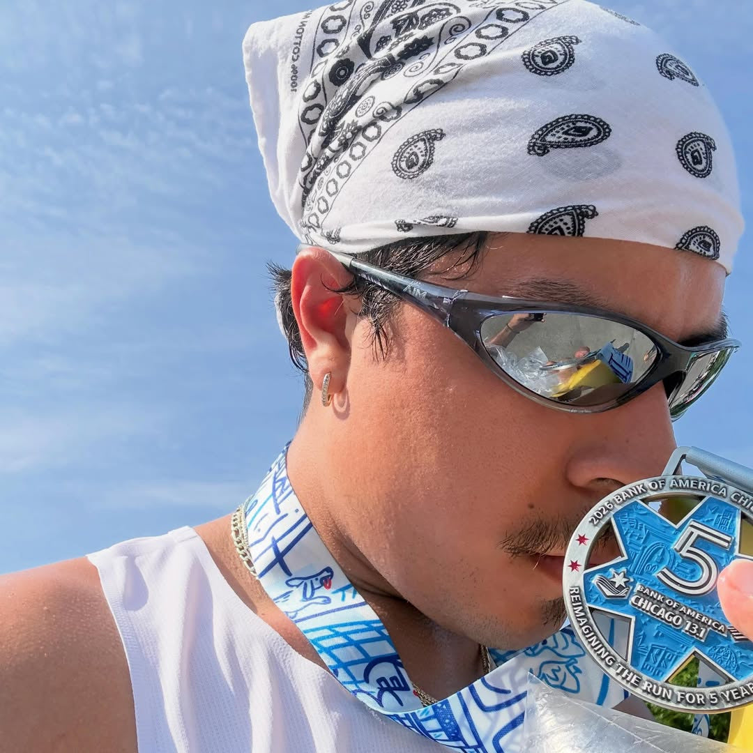 Customer wearing AIM Black Crystal sunglasses — post-race medal portrait