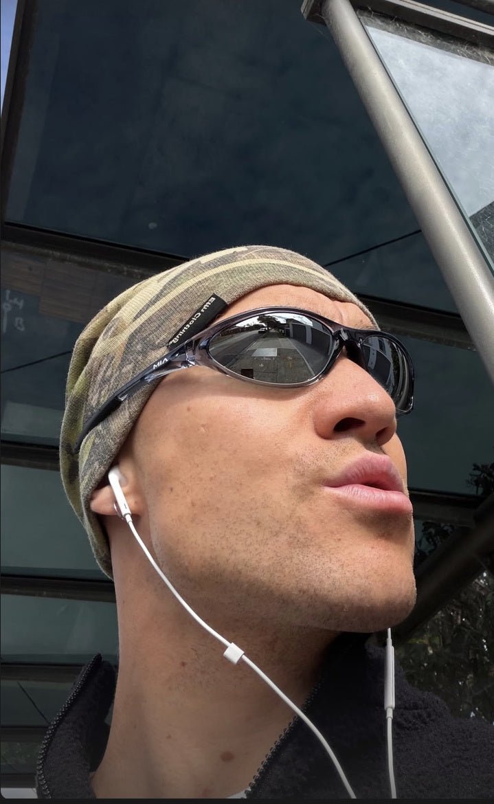 Customer wearing AIM Black Crystal sunglasses — phone close-up
