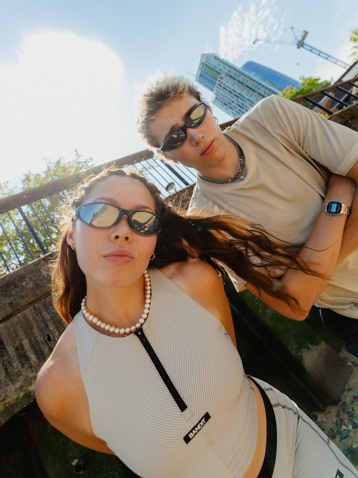 Customer wearing AIM Black Crystal sunglasses — two friends overhead portrait