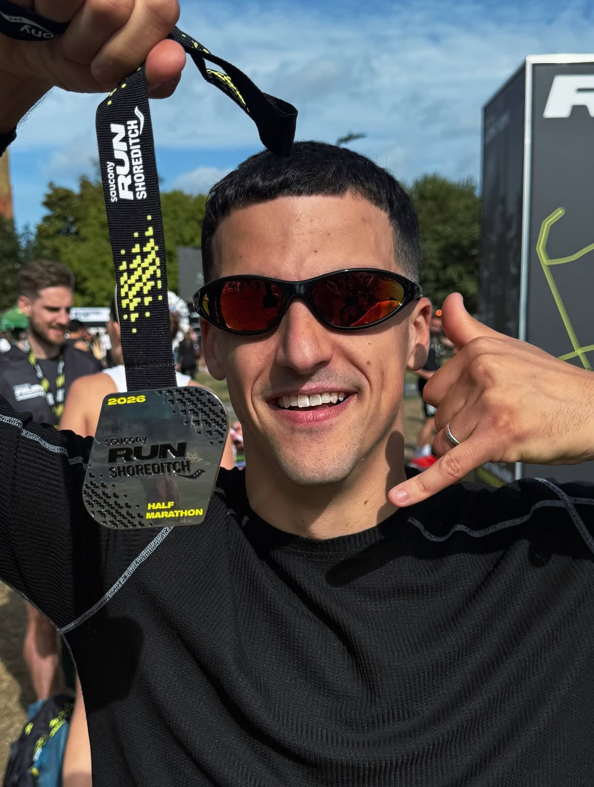 Customer wearing AIM Black Heat sunglasses — post-race close-up