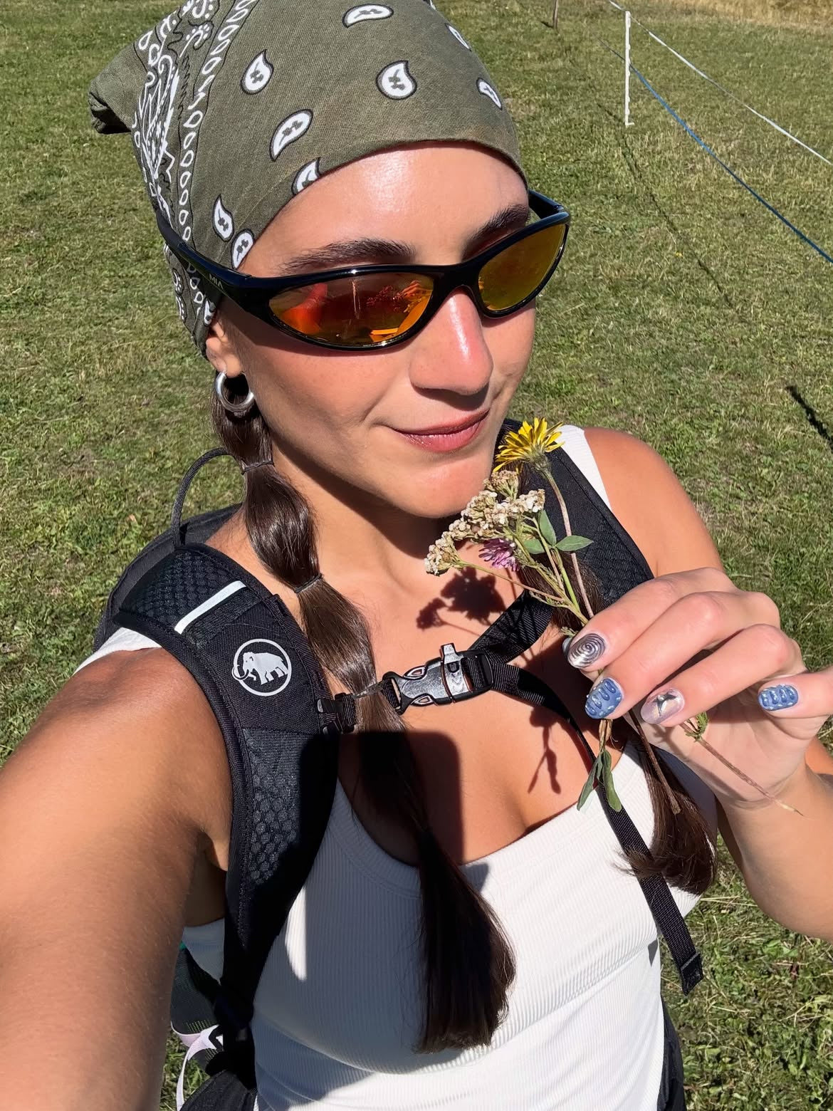 Customer wearing AIM Black Heat sunglasses — mountain portrait