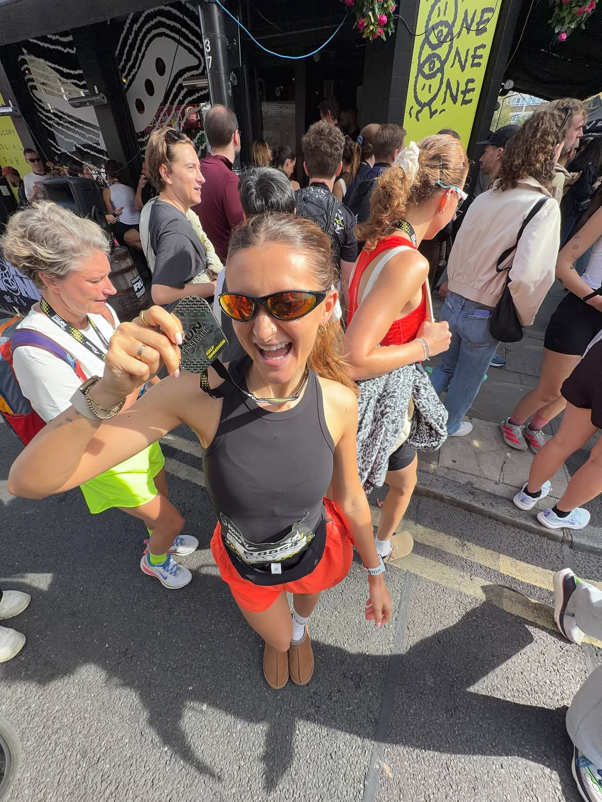 Customer wearing AIM Black Heat sunglasses — high-angle race portrait