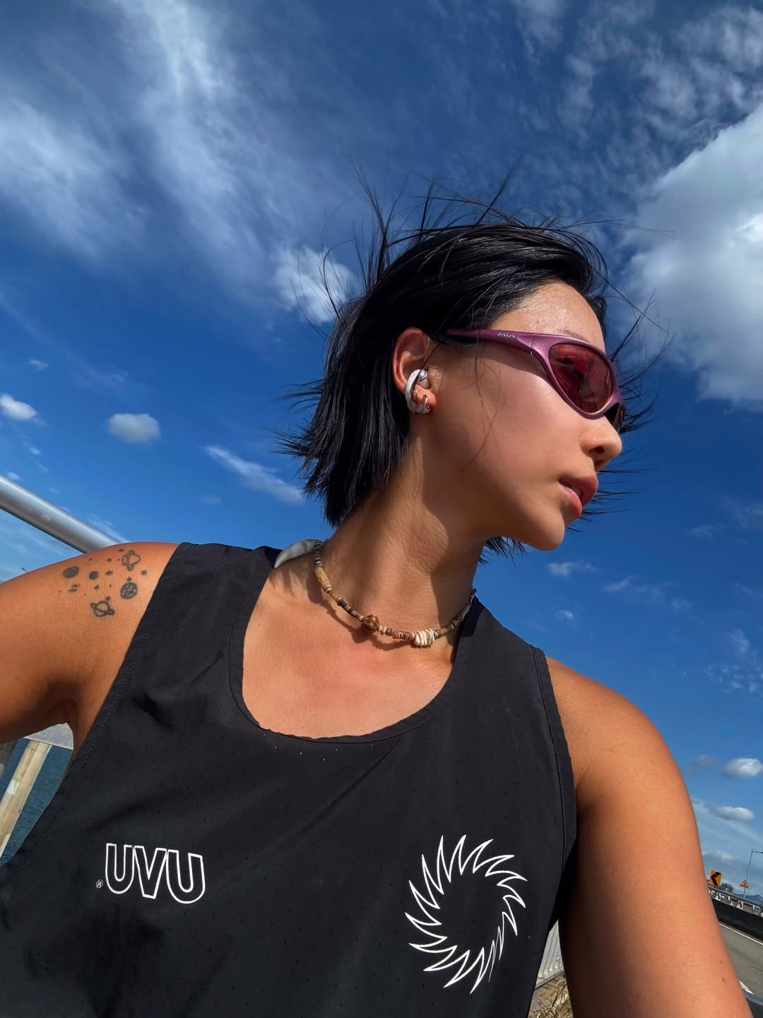 A customer wearing AIM Sunnies - Dusk Road