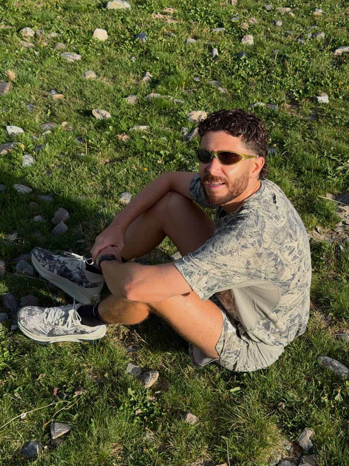 Customer wearing AIM Forest sunglasses — seated forest portrait