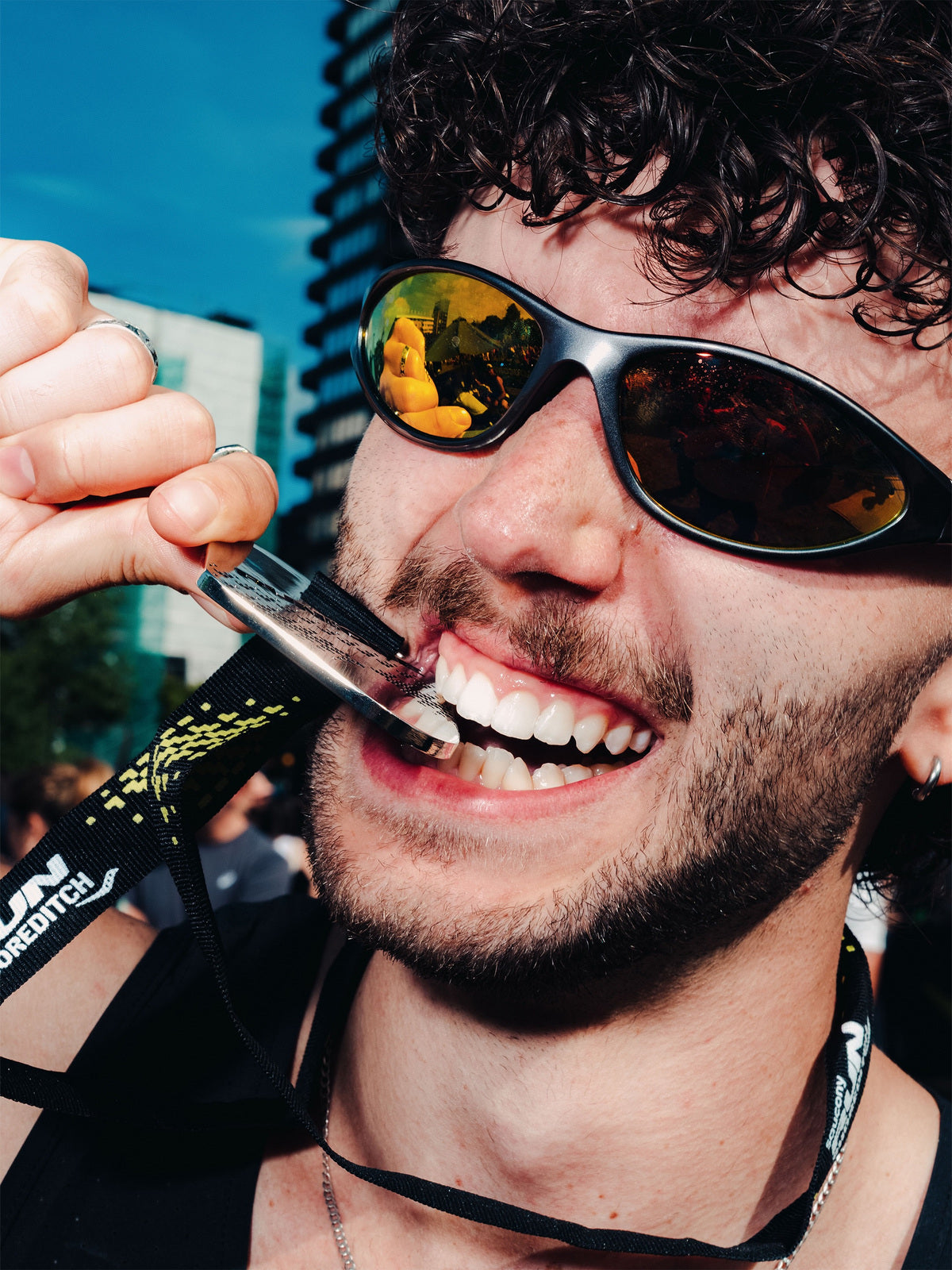 Customer wearing AIM Gunmetal sunglasses — medal close-up