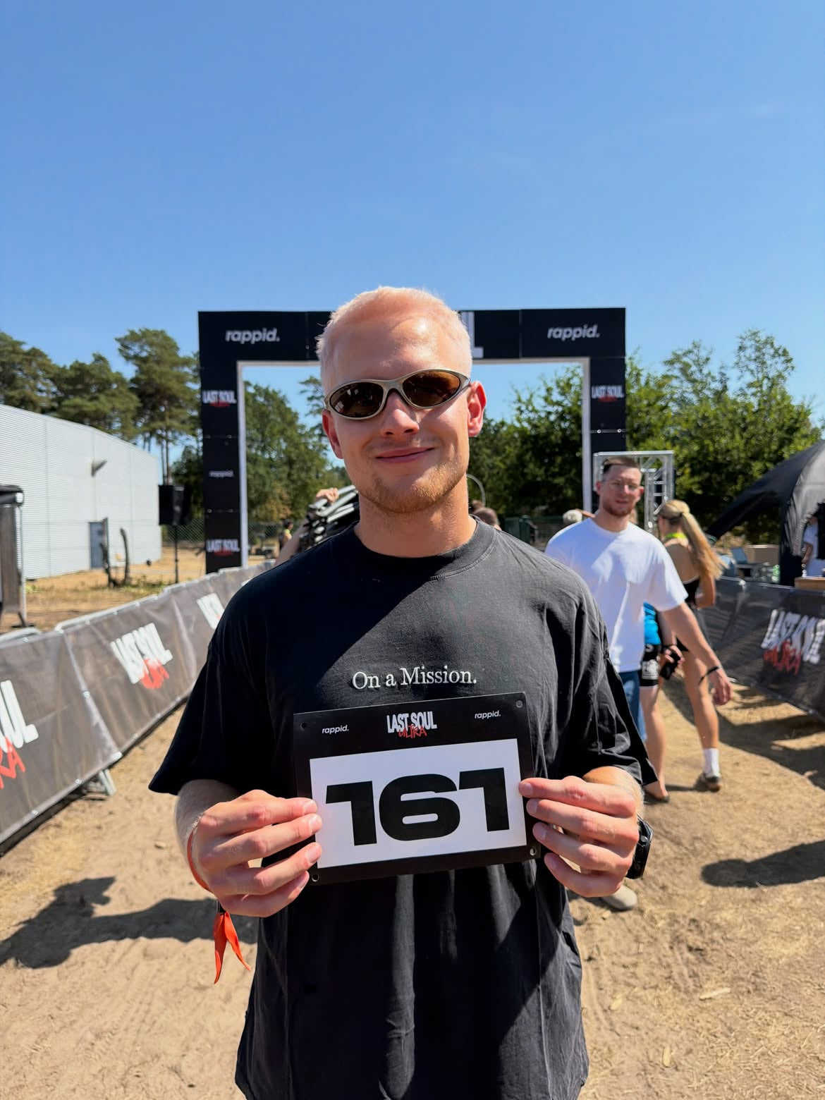 Customer wearing AIM London Gold sunglasses — post-race portrait