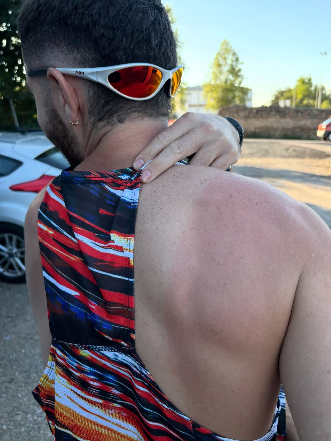 Customer wearing AIM Pearl Heat sunglasses — overhead running portrait