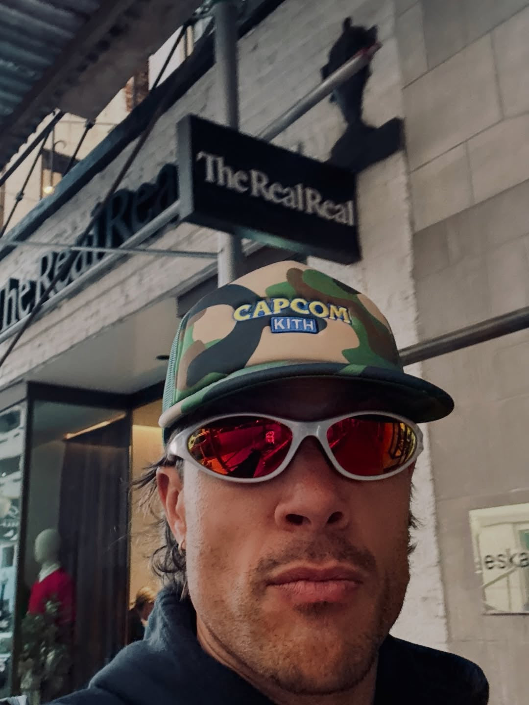 Customer wearing AIM Pearl Heat sunglasses — casual city portrait