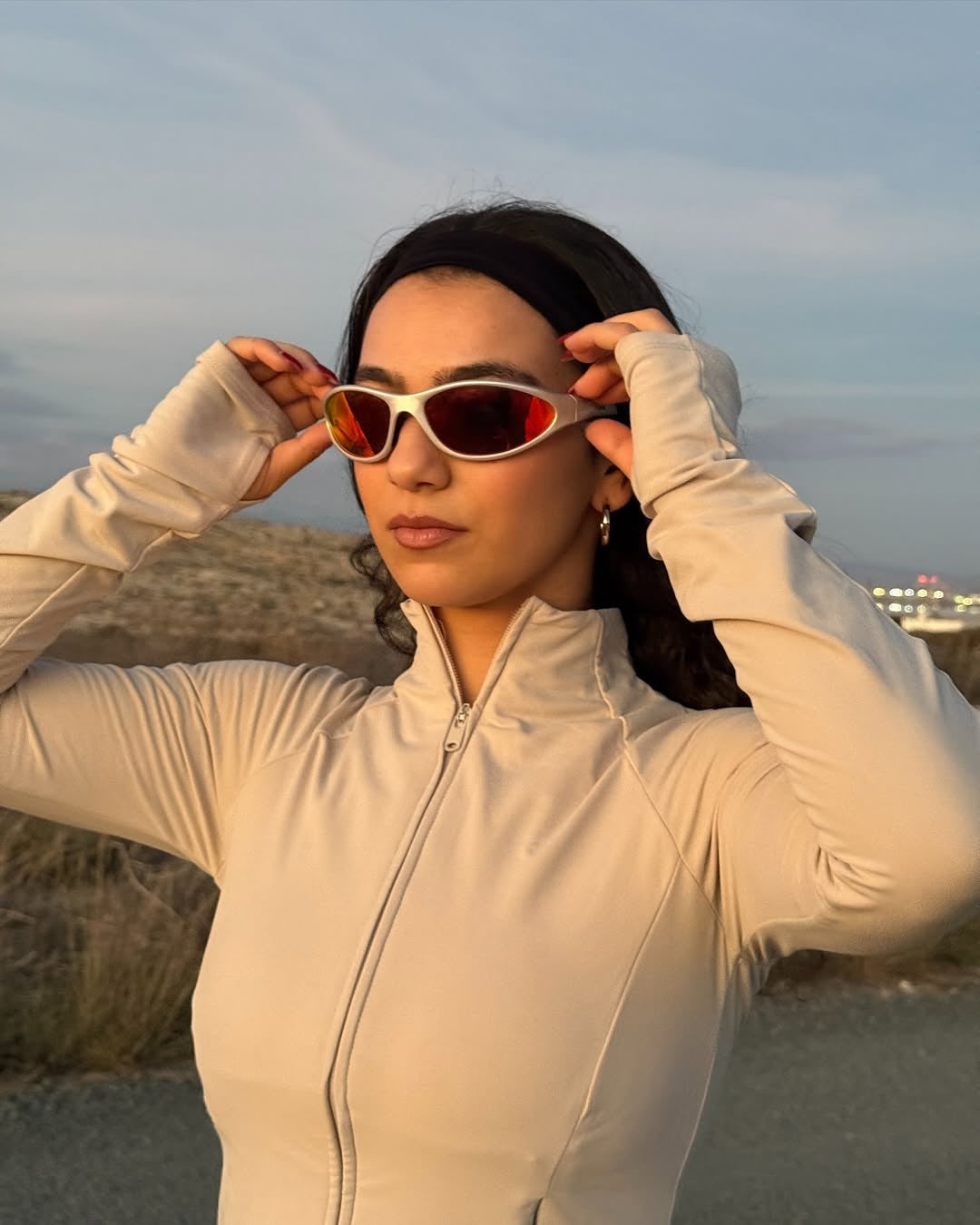 Customer wearing AIM Pearl Heat sunglasses — golden-hour close-up