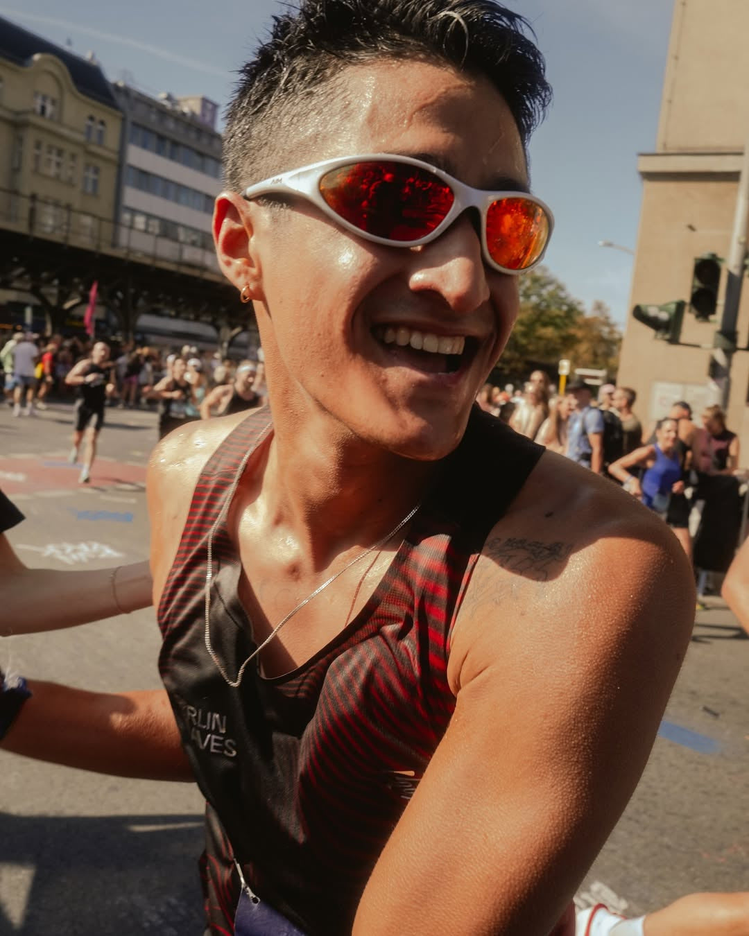 Customer wearing AIM Pearl Heat sunglasses — post-race portrait