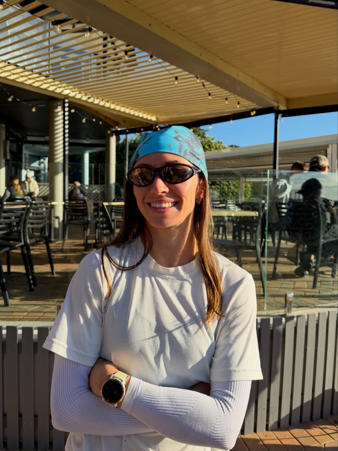 Customer wearing AIM Tortoise sunglasses — cafe portrait
